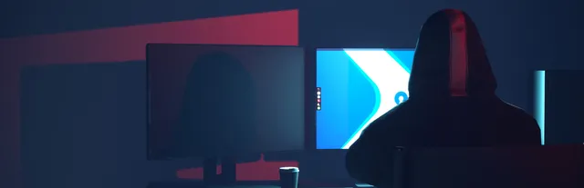 Hacker Simulator key art: a hooded hacker sitting in front of two monitors
